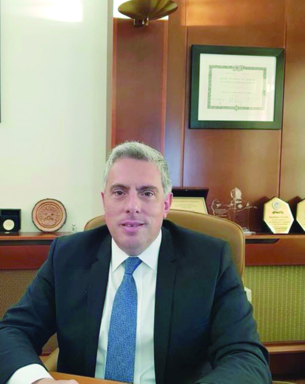 His Excellency Lebanese Ambassador in formal diplomatic attire with Lebanese flag